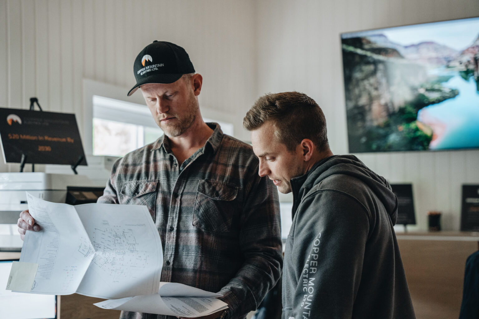 Electrical contractors collaborating in the office